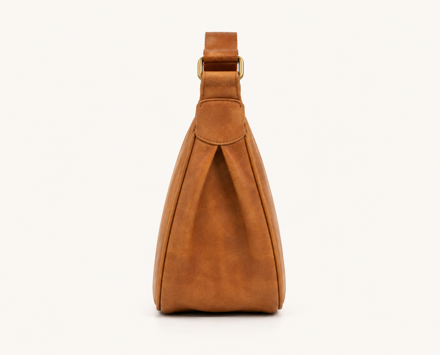 Frounder Luna sling in camel full-grain leather, rear view showing the single strap and solid brass hardware