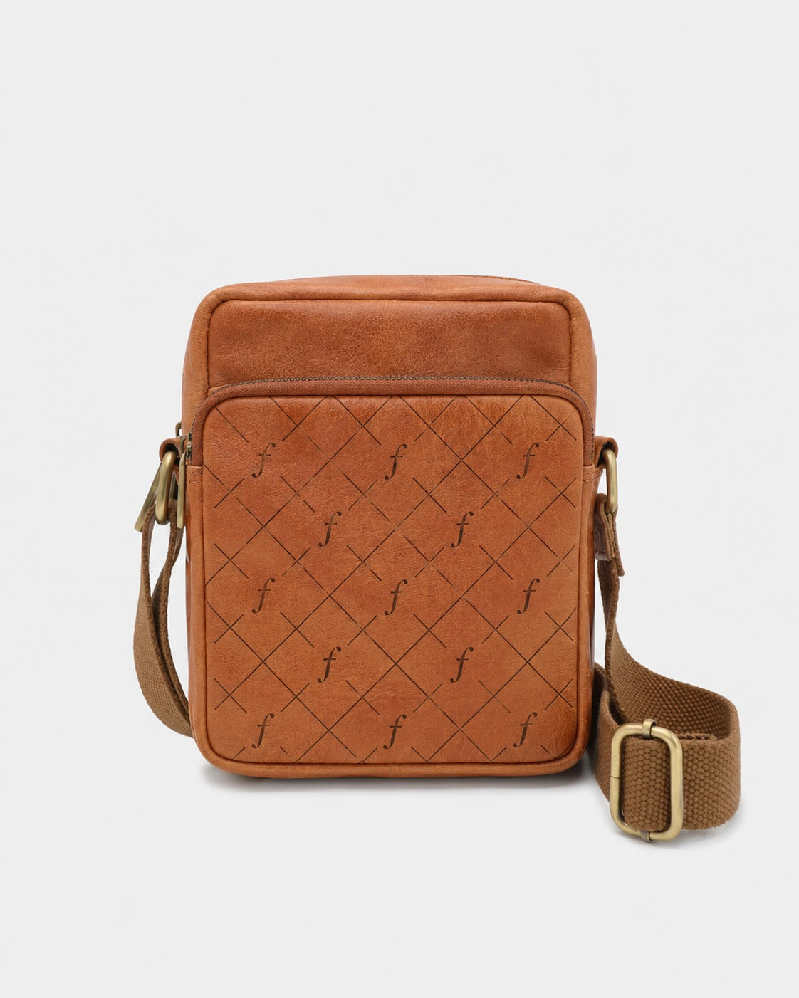 Brown leather crossbody bag with quilted pattern on a light gray background
