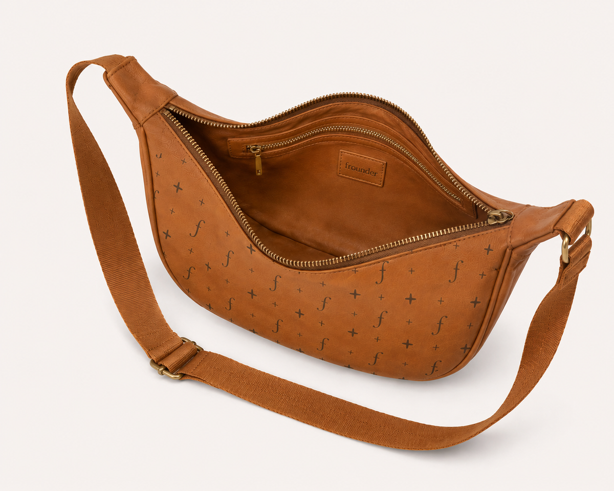 Tan Frounder Luna leather sling bag shown open with adjustable strap