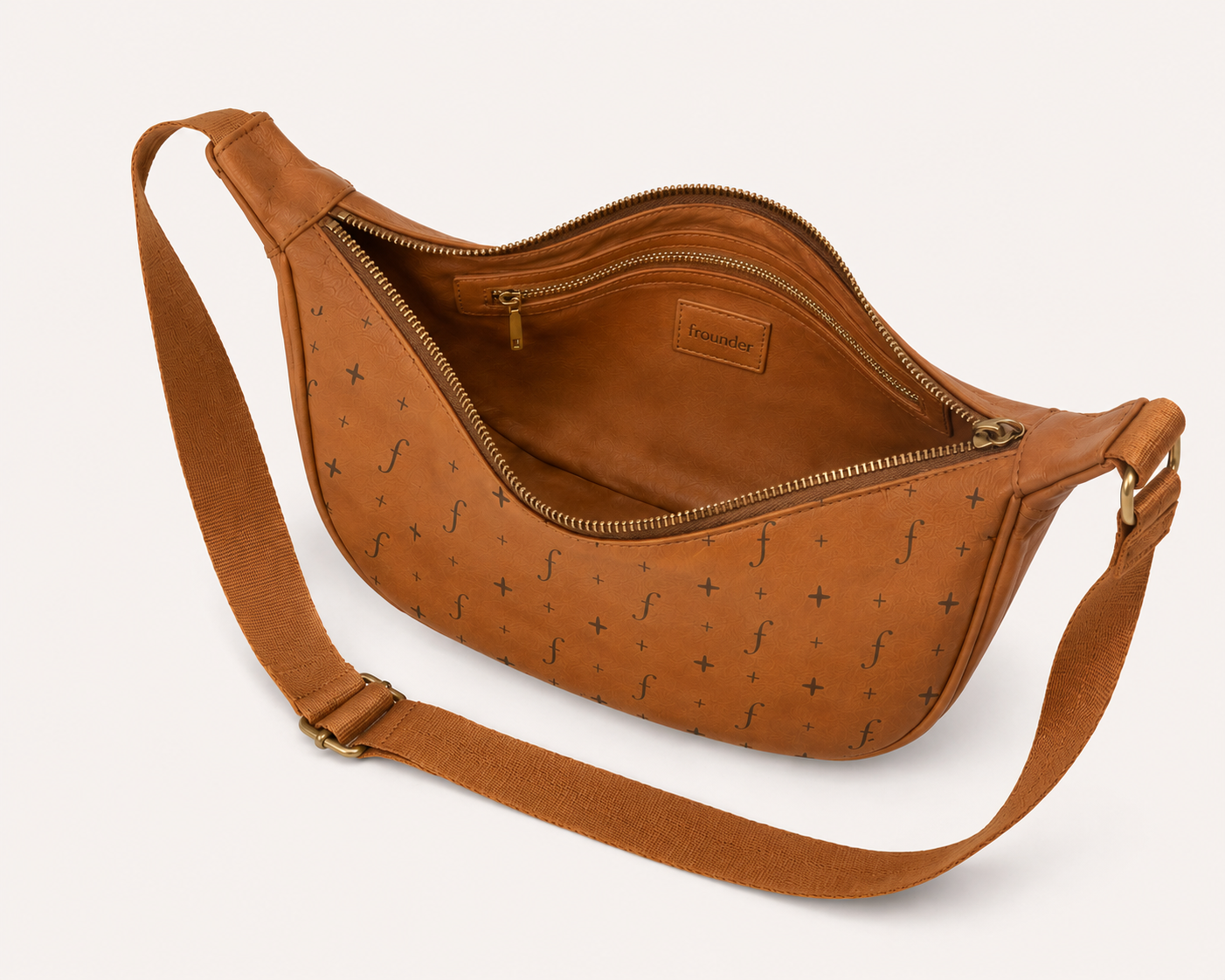 Tan Frounder Luna leather sling bag shown open with adjustable strap