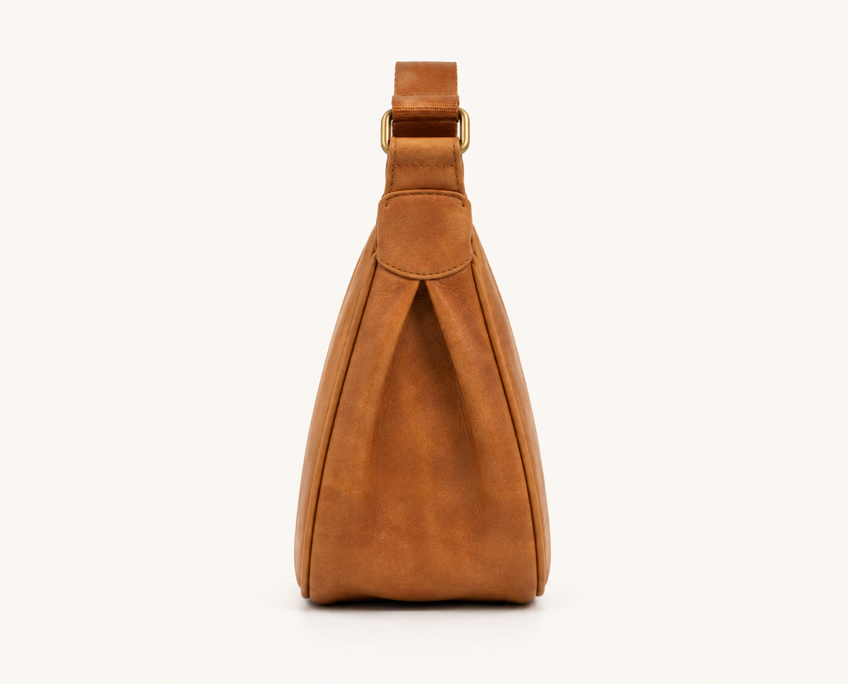 Frounder Luna sling in camel full-grain leather, rear view showing the single strap and solid brass hardware