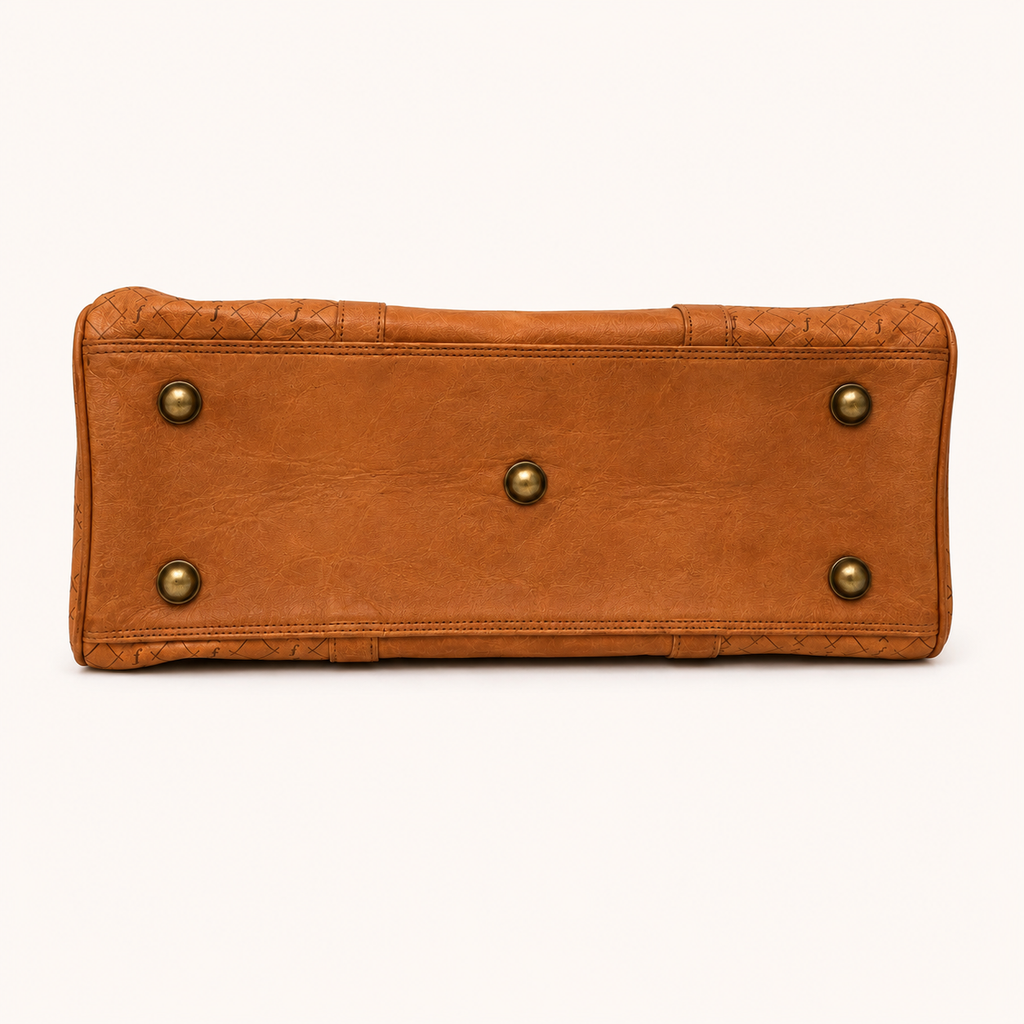 Brown leather bag with gold studs on a white background
