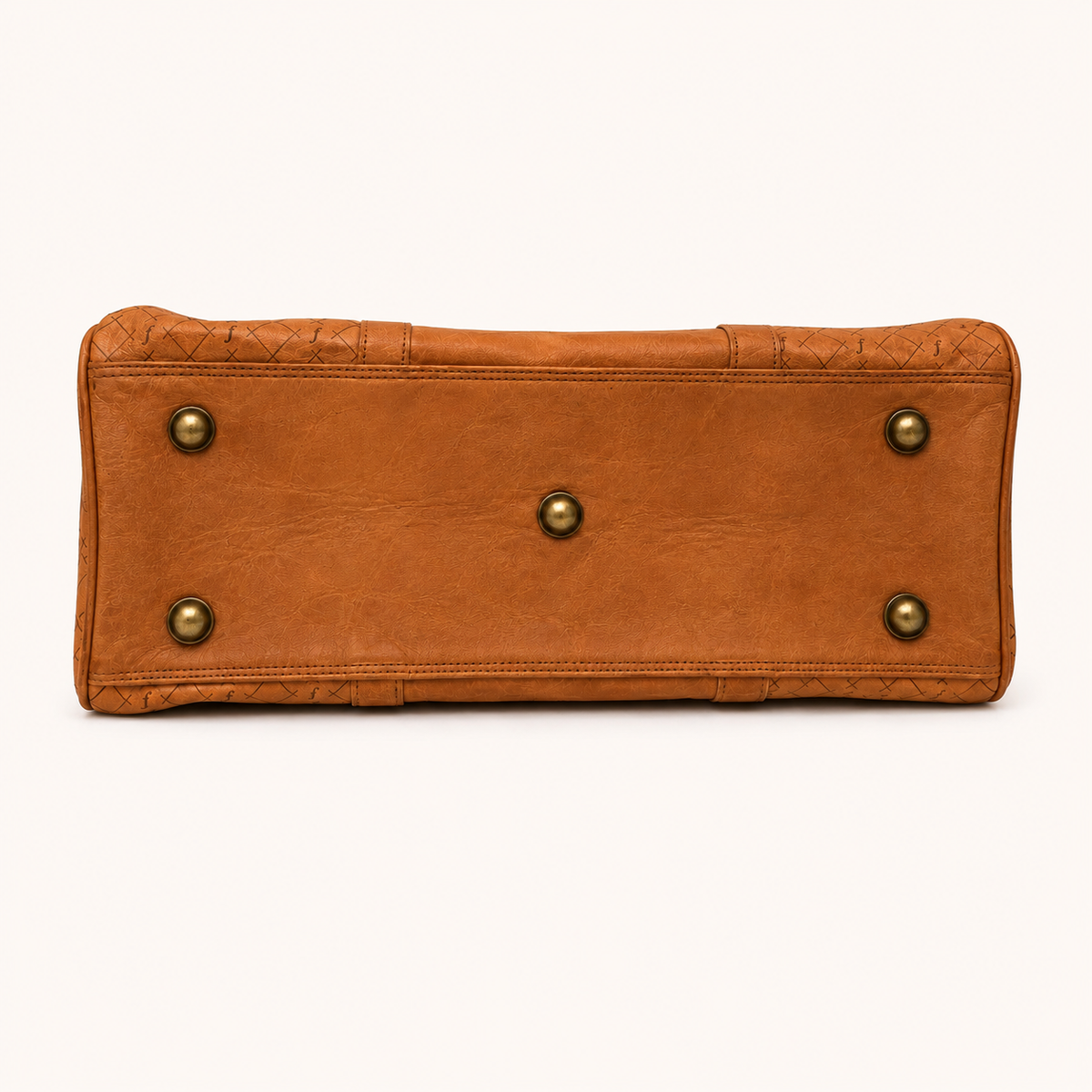 Brown leather bag with gold studs on a white background