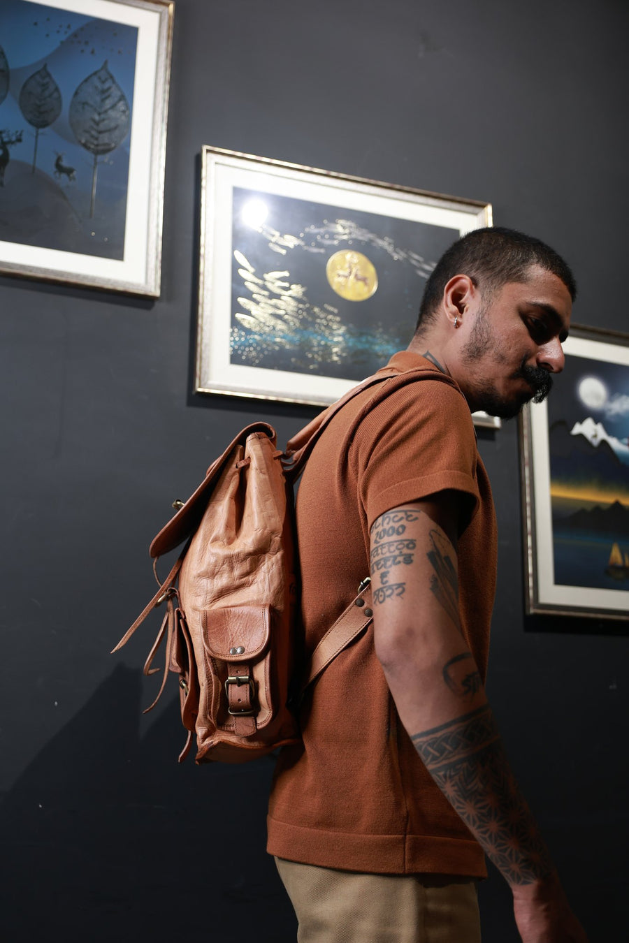 Frounder Helios leather backpack worn on the back, drawstring flap and front buckle pocket