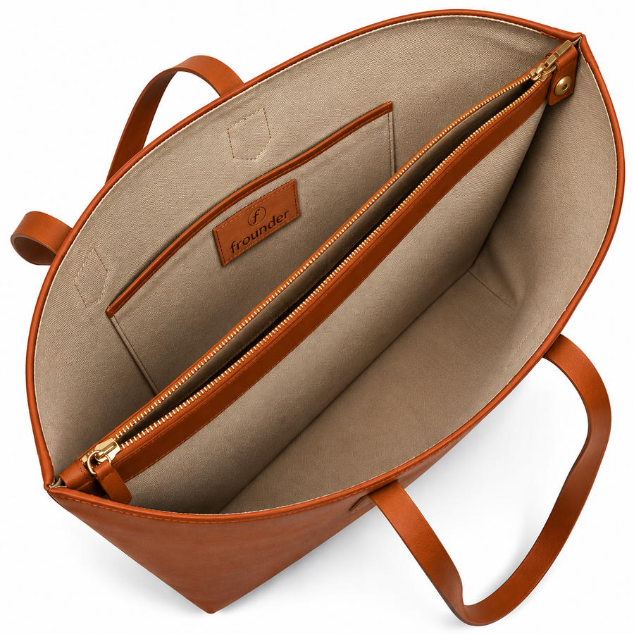 The Altair tote open, showing the cotton lining, an interior zip pocket and the Frounder patch stitched to the lining.