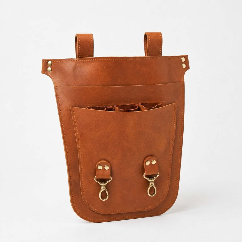 A brown leather utility pouch with two top hanging loops and a large front pocket, shown on a clean white background.