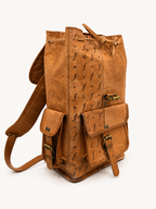 Brown leather backpack with decorative patterns on a white background