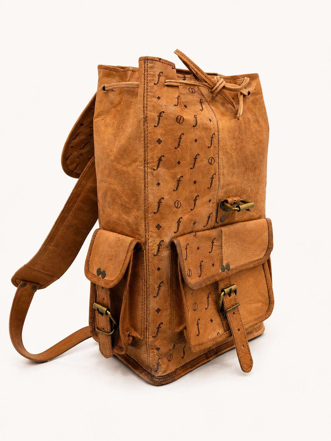 Brown leather backpack with decorative patterns on a white background