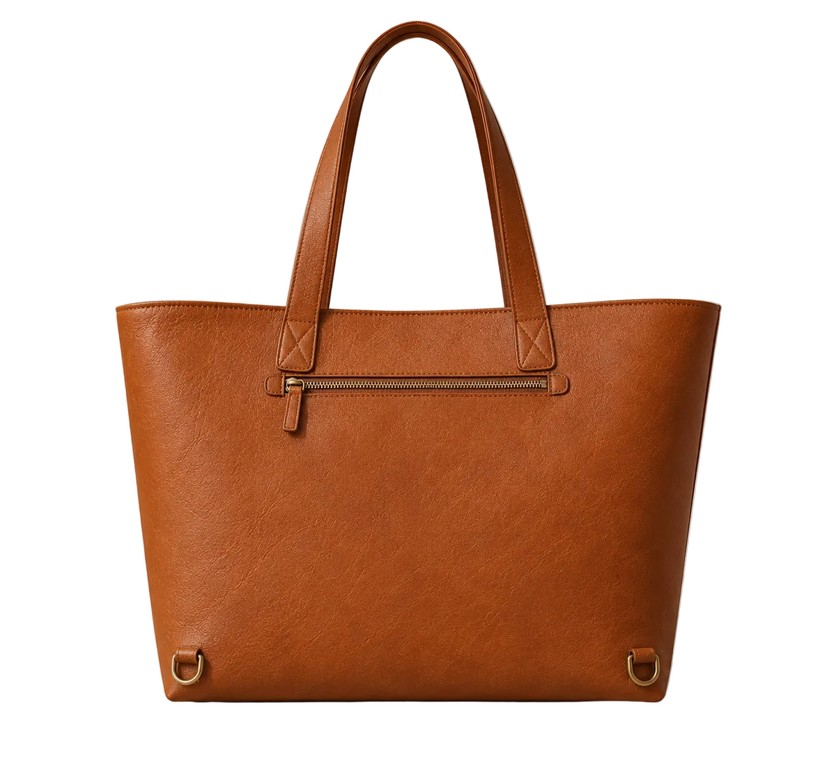 A structured tan leather tote bag with double top handles, a front zippered pocket, and brass-tone hardware, photographed on a light stone surface against a softly lit neutral wall with a small plant at the side.