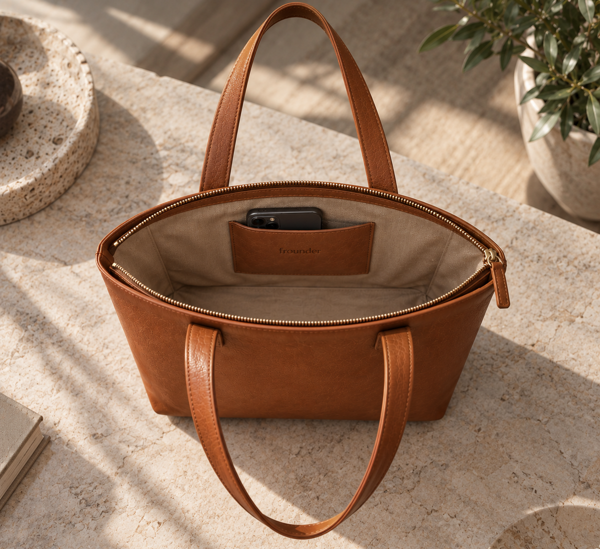 Frounder Polaris leather tote shown open, with a beige lining and an interior leather pocket embossed with the Frounder mark