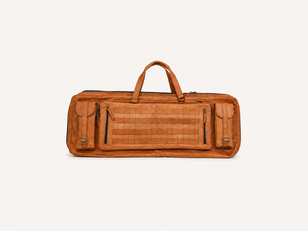 Frounder Solstice full-grain leather rifle bag in brown, with a top handle, zippered pockets and a quilted centre panel