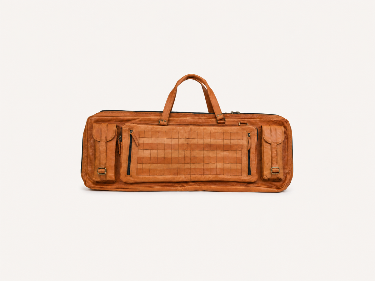Frounder Solstice full-grain leather rifle bag in brown, with a top handle, zippered pockets and a quilted centre panel