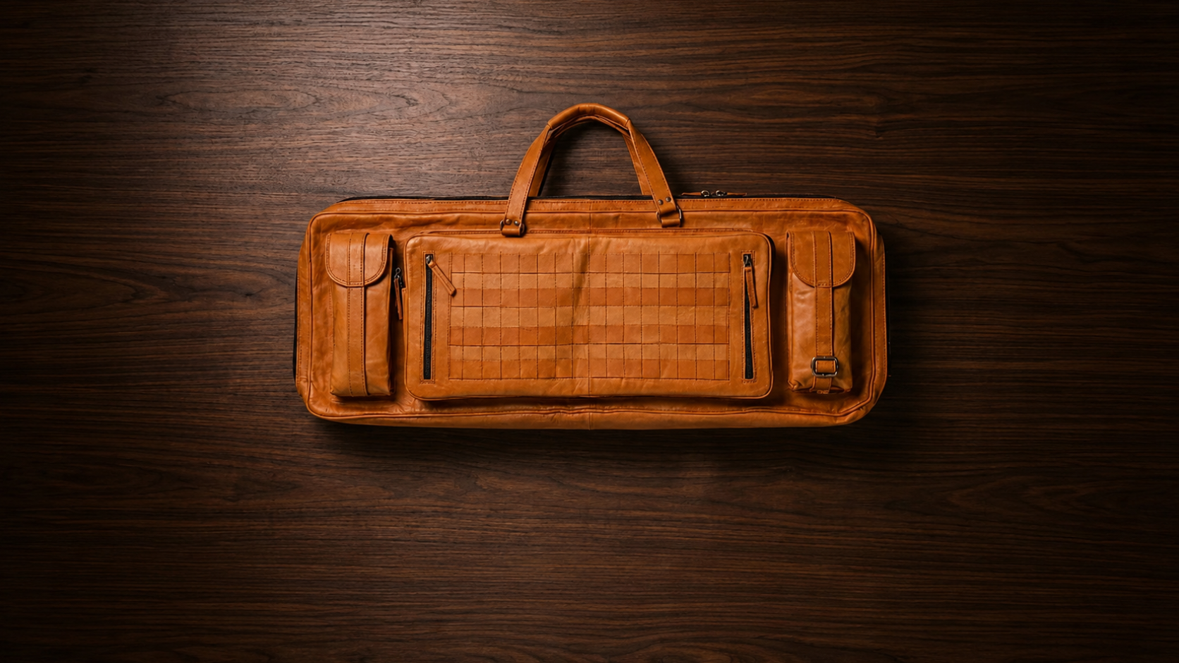 Frounder Solstice leather rifle bag laid flat, showing the dual top handles and zippered accessory pockets